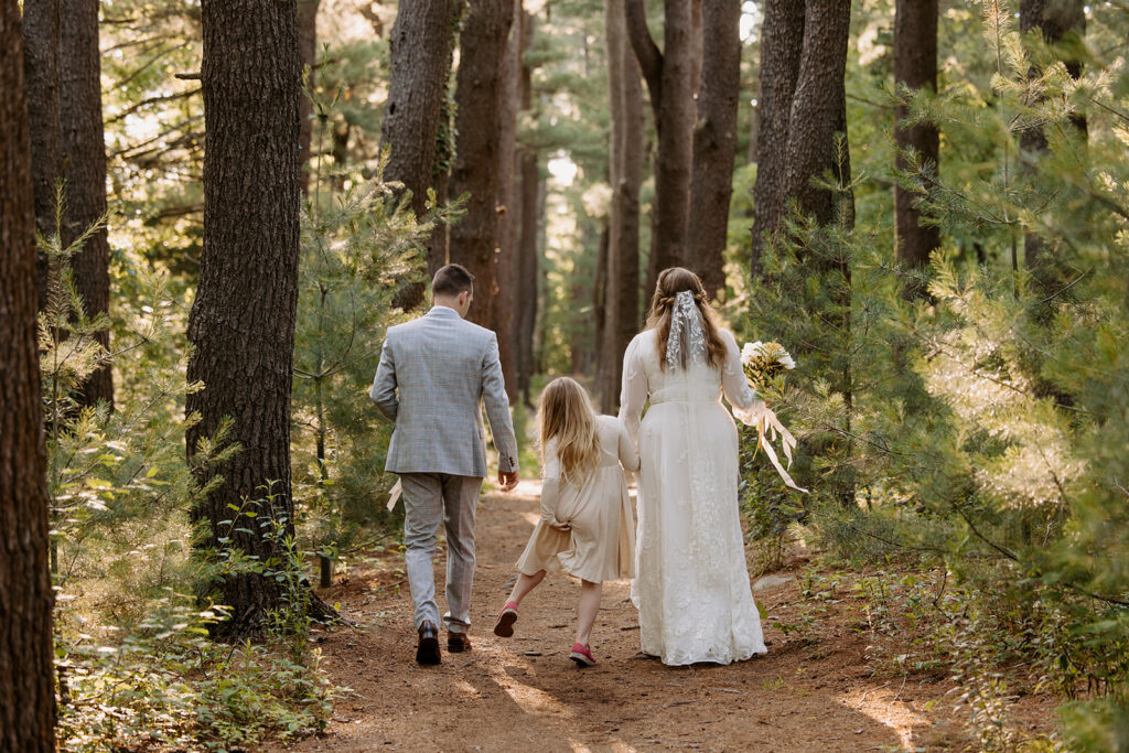 Elopement photo of Daughter walking with parents 